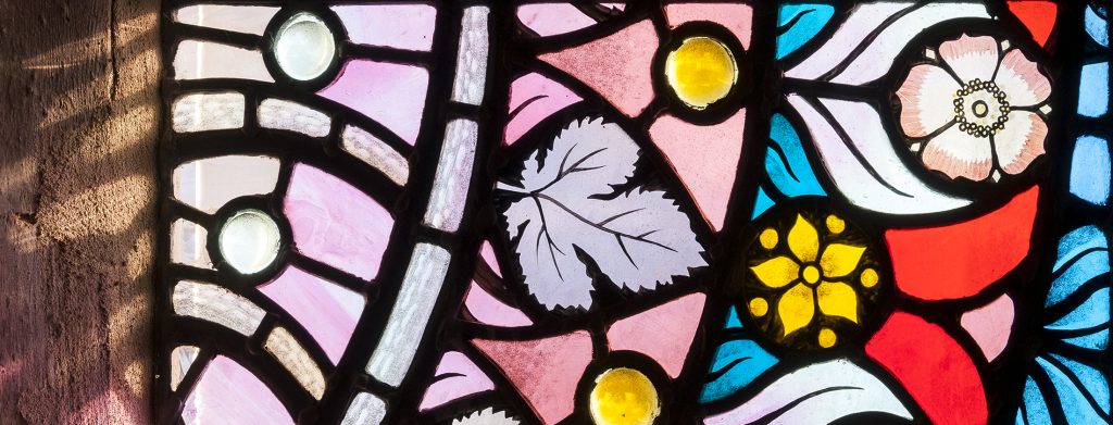 Detail of patterned stained glass by John Petts.